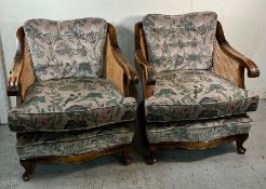 A pair of Bergère armchairs with scrolling arms (H77cm W77cm D60cm)