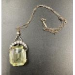 A vintage pendant with diamond crescent and central stone