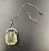 A vintage pendant with diamond crescent and central stone
