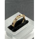 A 9ct garnet and opal ring (Approximate weight 2.5g) Missing a stone.