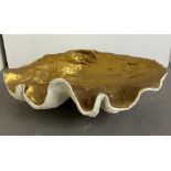 A giant faux clam shell, inside gilded painted (H23cm W64cm D38cm)