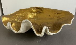 A giant faux clam shell, inside gilded painted (H23cm W64cm D38cm)