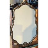 A scrolling gilt framed mirror