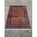 A red medallion wool rug/carpet (230cm x 140cm)