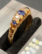 A sapphire and diamond ring, with three sapphires and two diamonds in alternate style with central