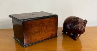 A mahogany tea caddy and wooden Hippo