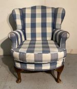 A mahogany framed wing back arm chair, upholstered in blue and white check