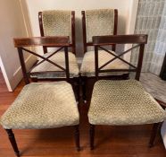 Two matched pairs of dining chairs.