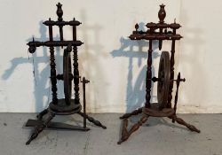 Two antique small upright castle style spinning wheels on turned tripod legs
