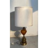 A vintage amber hobnail glass lamp on brass relief base