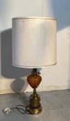 A vintage amber hobnail glass lamp on brass relief base