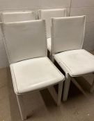 A set of four ivory leather upholstered dining chairs