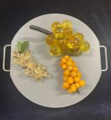 Decorative mix of glass grapes on a two handled chopping board