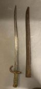 A vintage brass handled bayonet in scabbard