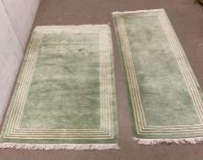 Two wool rugs with green grounds 185cm x 64cm and 162cm x 87cm