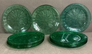 Eleven green glass plates with floral detail