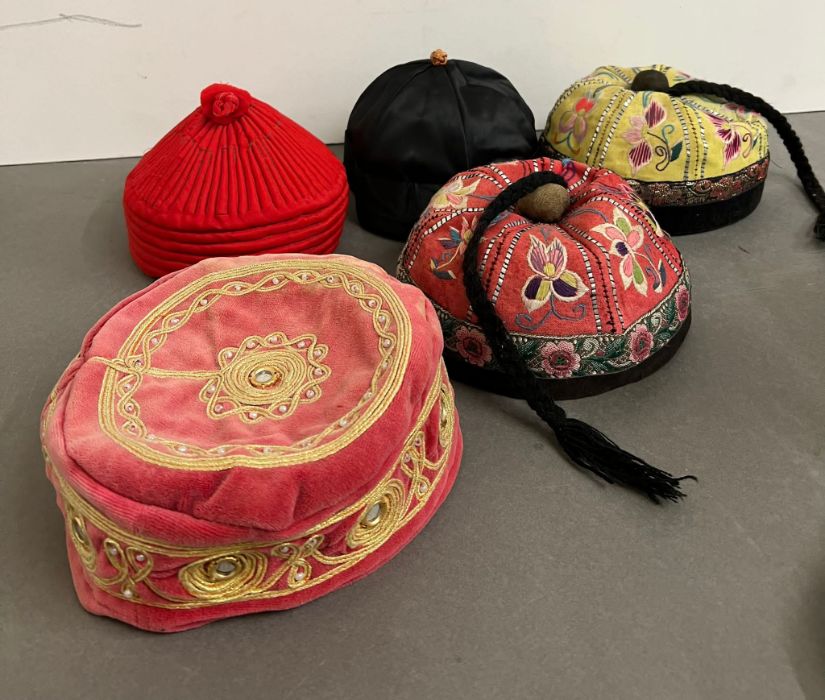 A selection of Nepalese and mandarin embroidered smoking caps.