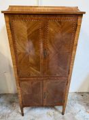 An inlaid secretaire style side cabinet opening to shelfs and pull out writing drawer on tapering