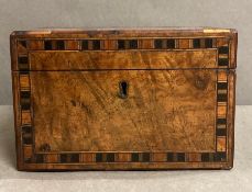 An antique rosewood tea caddy with inlay.