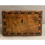 An antique rosewood tea caddy with inlay.