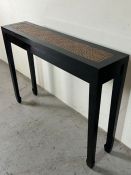 A narrow console table with a rattan style top (H82cm W110cm D26cm)