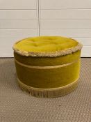 A vintage foot stool upholstered in green