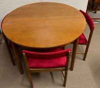 A McIntosh teak table and four chairs (H77cm Dia114cm)