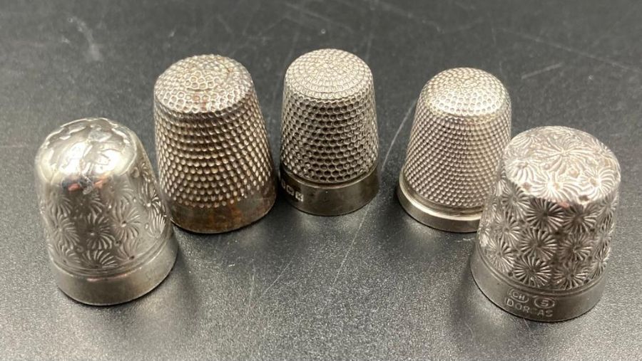 A selection of five thimbles two by Charles Horner, two silver and one other.