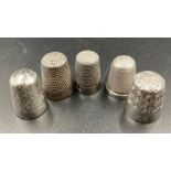 A selection of five thimbles two by Charles Horner, two silver and one other.