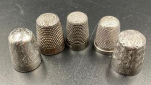 A selection of five thimbles two by Charles Horner, two silver and one other.