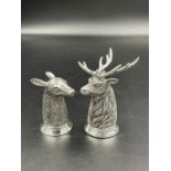 An 800 mark silver salt and pepper in the form of a stag and a deer.