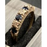 A 9ct gold ring set with alternating diamonds and sapphires Size O1/2
