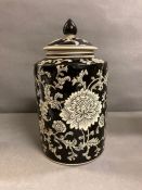 An India Jane of London black painted lidded jar with floral motif