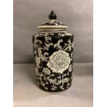 An India Jane of London black painted lidded jar with floral motif