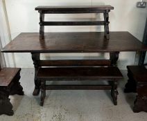An oak dining room table along with two long bench seats and two small bench seats