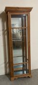 A pine glass display unit with four glass shelves and mirrored back (H187cm W66cm D40cm)