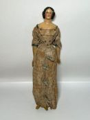 A Victorian doll with silk and cotton dress, wooden legs (H40cm)
