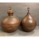 Two hammered metal lamp bases.