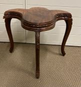 A unique mahogany and walnut side table in a crescent design