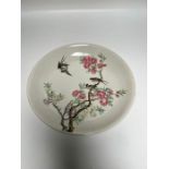 Oriental plate decorated with birds playing in a cherry blossom and double blue ringed mark to base