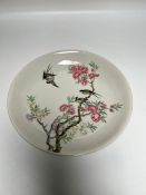 Oriental plate decorated with birds playing in a cherry blossom and double blue ringed mark to base