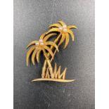 A 9ct gold and seed pearl brooch in the form of palm trees. (Approximate Total Weight 4.8g)