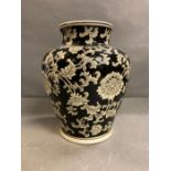 An India Jane of London black painted vase with floral motif