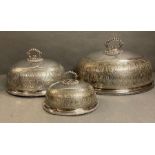 A set of three graduated silver plated dining domes with chased decoration and armorial to top by