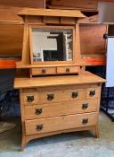 A Maple and Co oak seven drawer Art and Craft dressing table on splayed feet (H155cm D57cm W107cm)