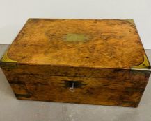A walnut writing box brass bound. Opening to writing slope, compartments with pearlized handles