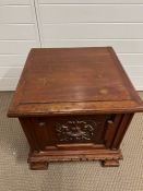 A mahogany carved box with hinged lid opening to storage 45sq x 46cm H