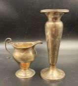 A silver milk jug and a hallmarked silver vase. Approximate Total weight 245g