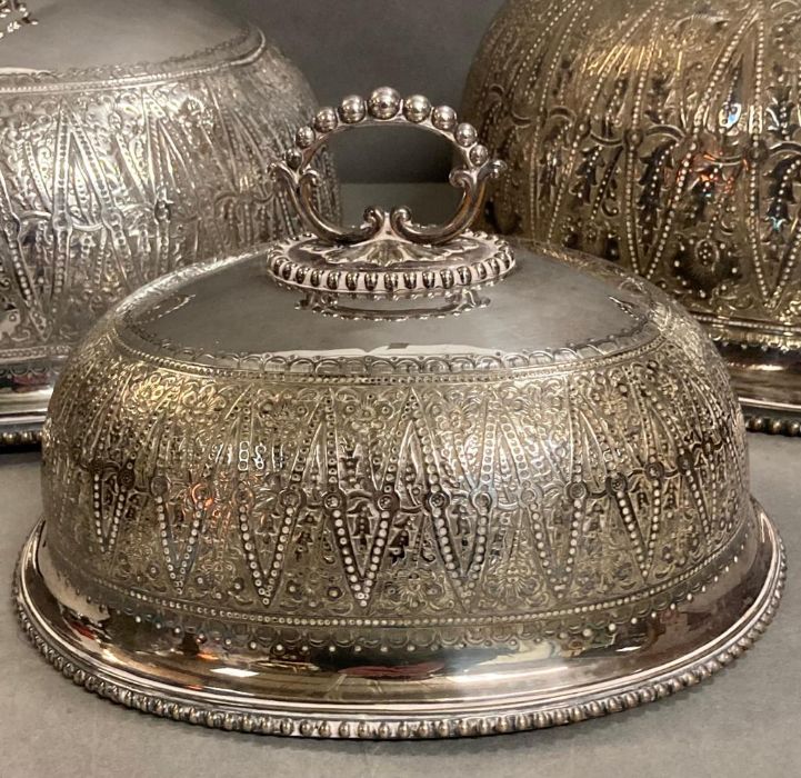 A set of three graduated silver plated dining domes with chased decoration and armorial to top by - Image 2 of 6