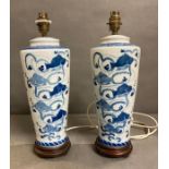 A pair of vintage blue and white Chinese table lamps with fish details